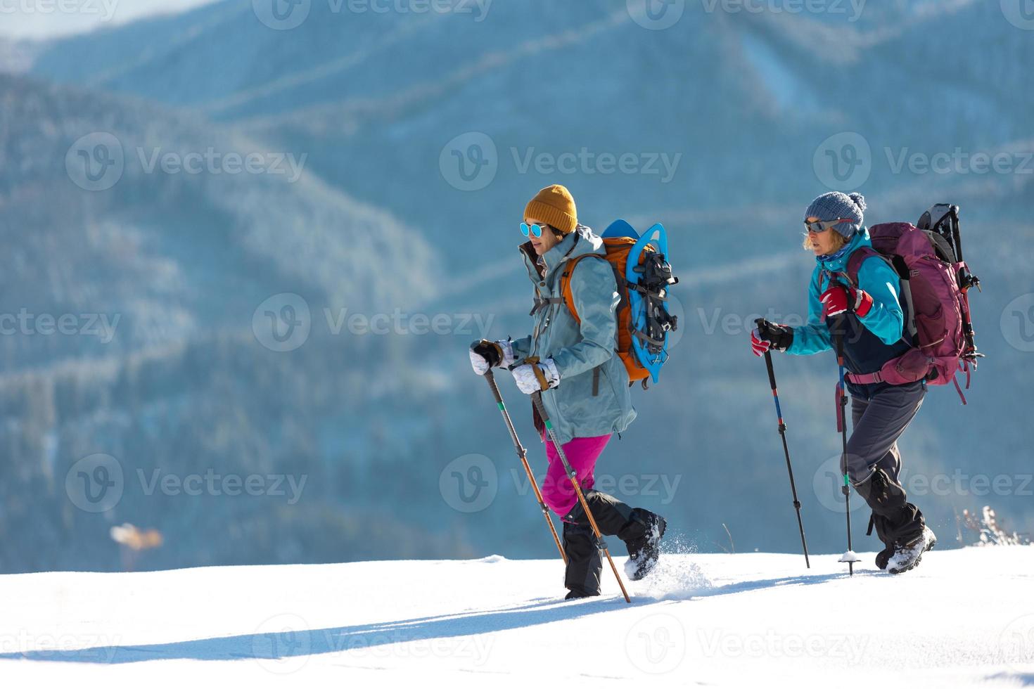 Two people in the mountains in winter photo