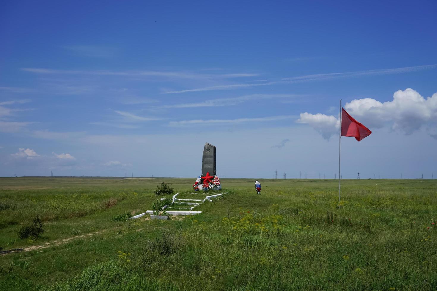Feodosia, Crimea-may 26, 2016 - Monument in the middle of the steppe with green grass against the blue sky. photo