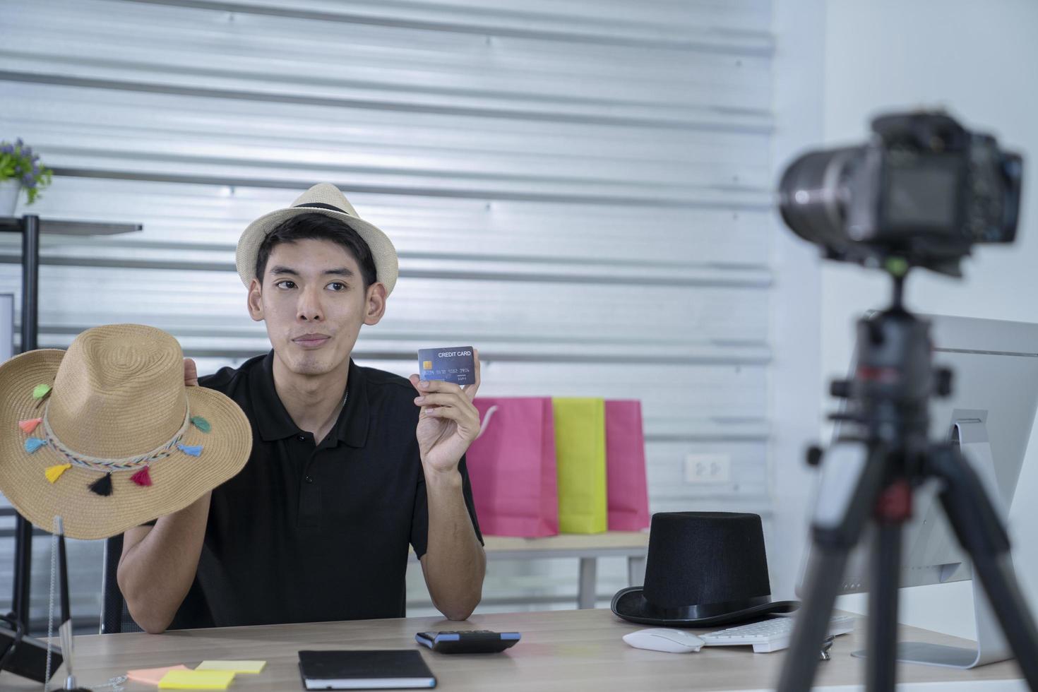 asian man blogger present and review product video broadcast live stream video to a social network. blogging, vlogging, online shopping, and social media concept photo
