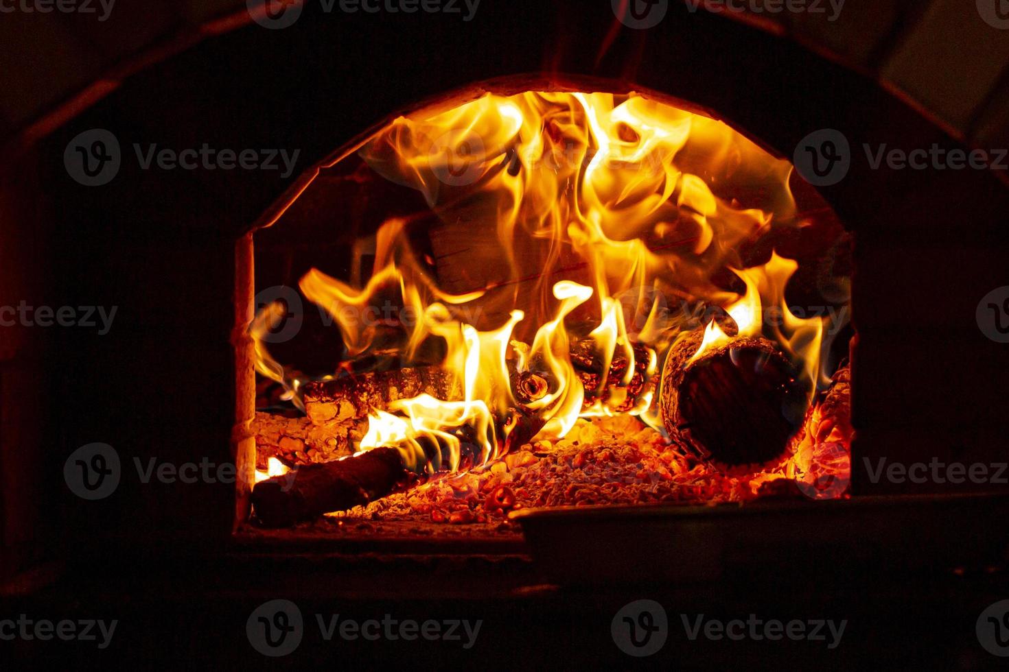 Burning log of wood in a fireplace close-up. photo