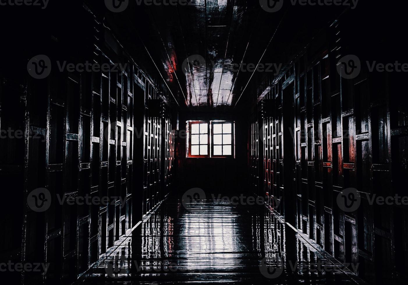 gloomy dark wooden corridor with closed doors of an empty hotel without people during quarantine photo