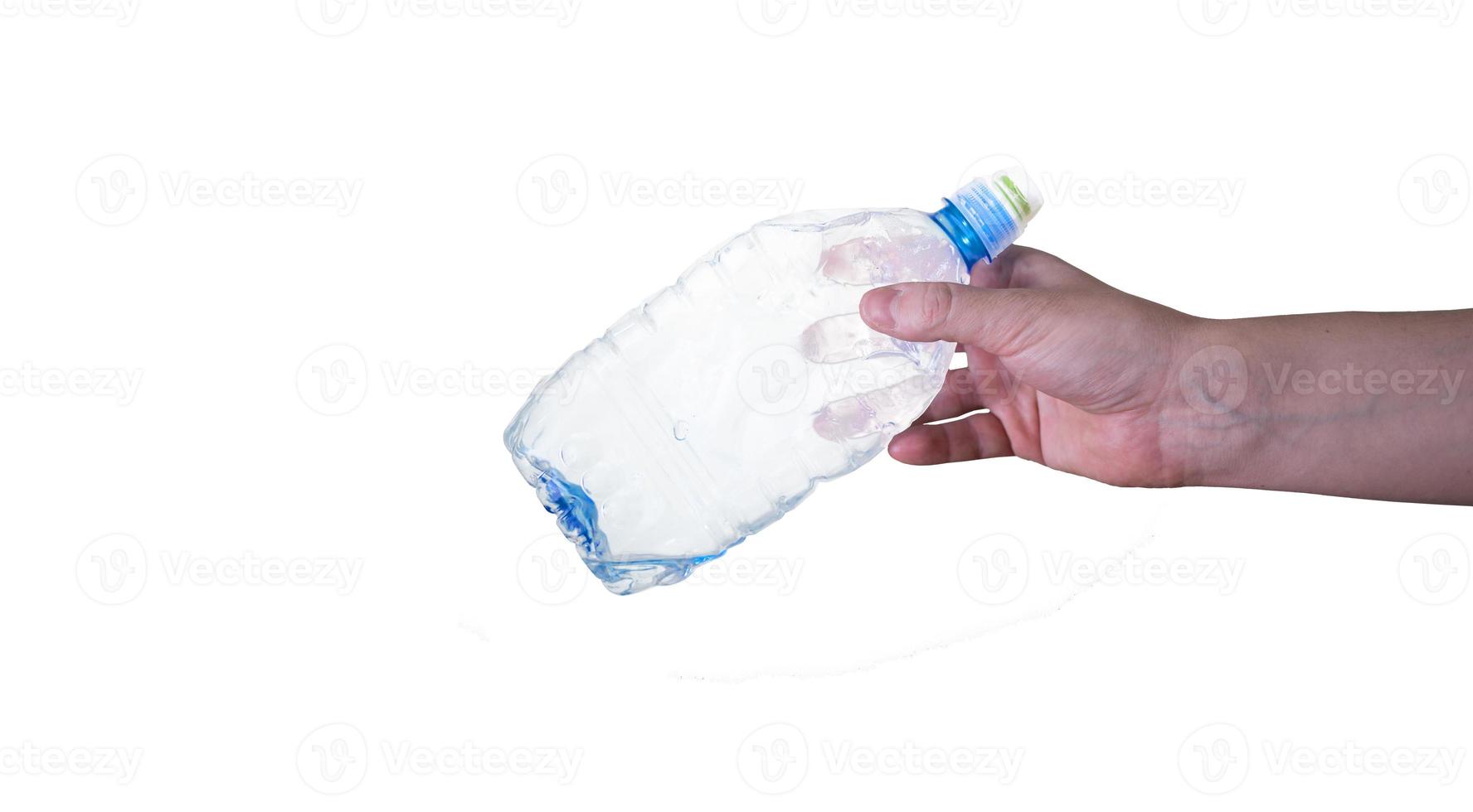 A man holding an empty, plastic bottle, isolated on a white background. photo