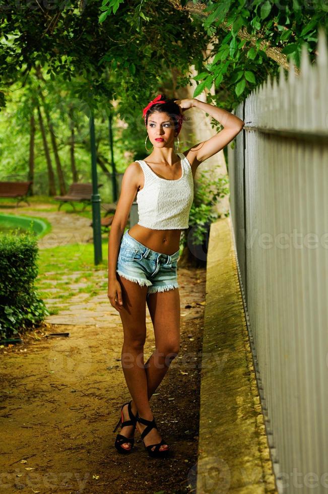 Pin-up girl. American style, in a garden photo