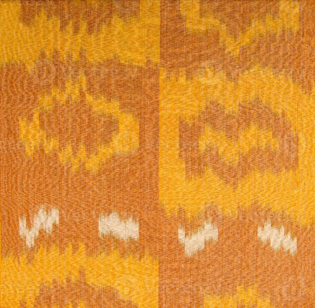 Background from the tissue with oriental ornaments and multi colored pattern, textile photo