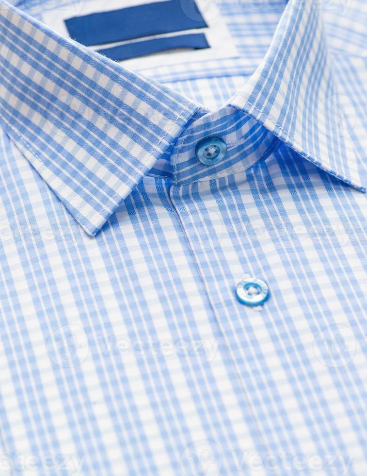 cotton shirt with a focus on the collar and button, closeup photo