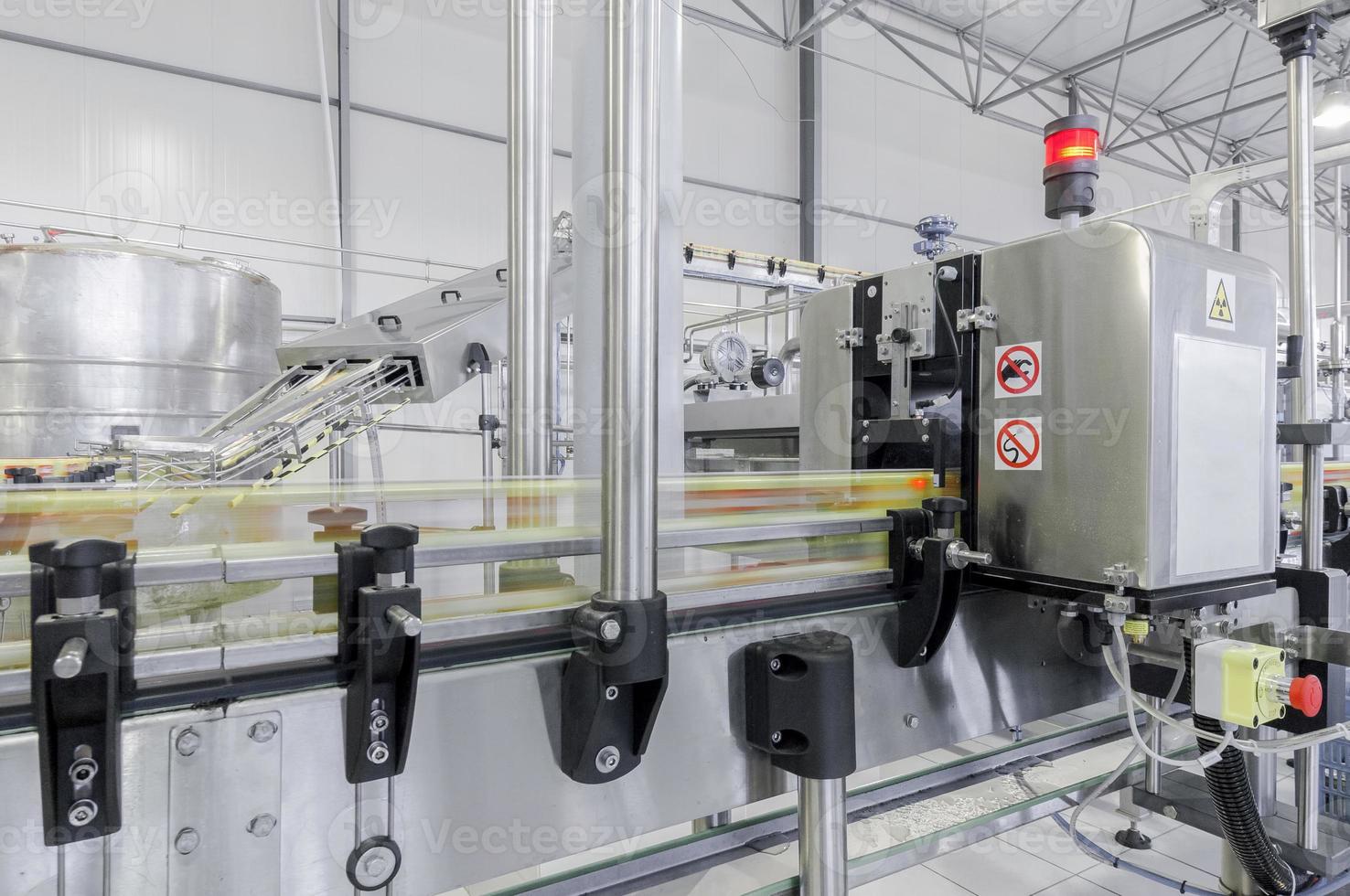 conveyor belt in motion at production and bottling of drinks in tin cans. production and bottling of drinks in tin cans photo