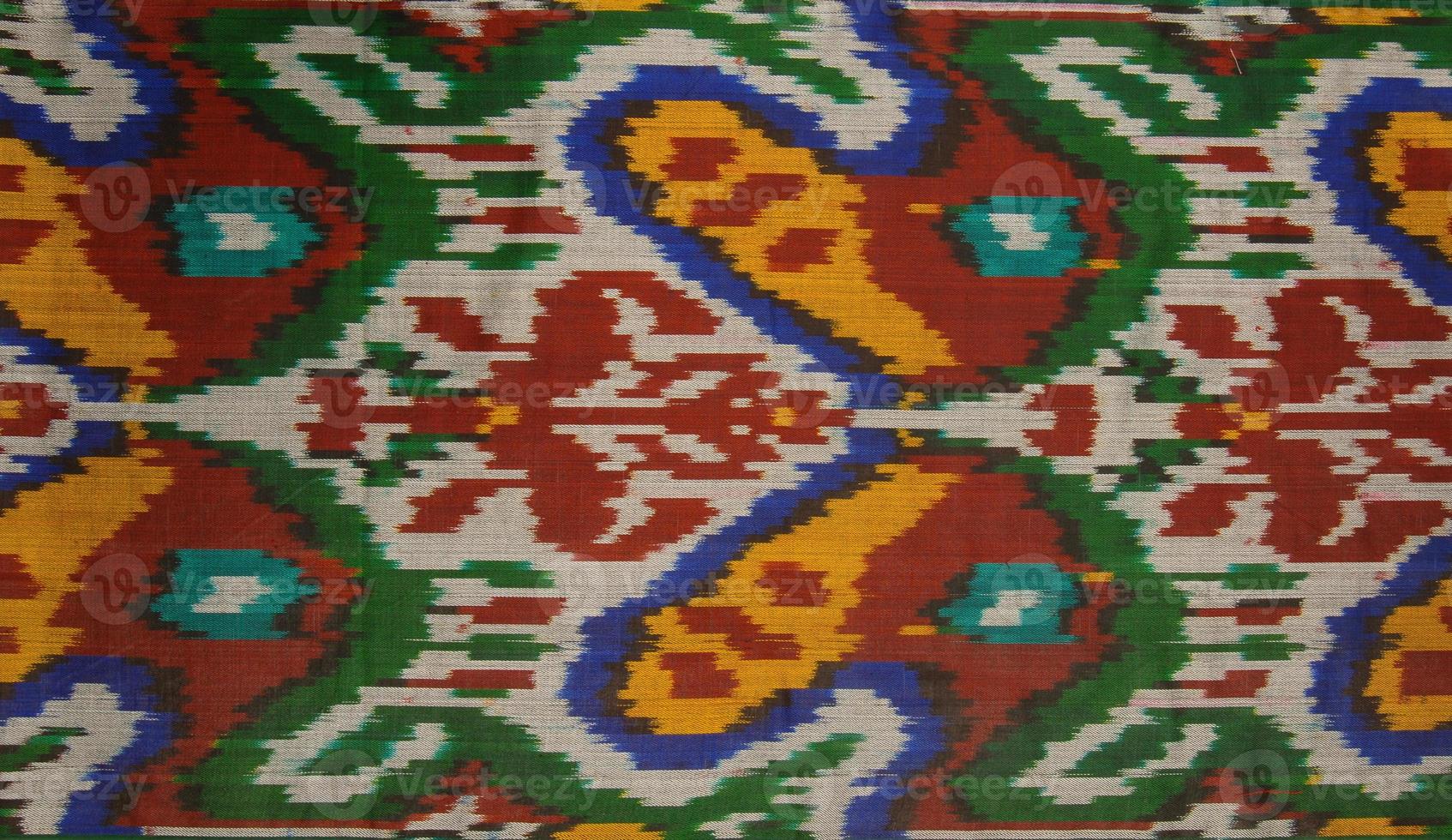 Background from the tissue with oriental ornaments and multi colored pattern, textile photo