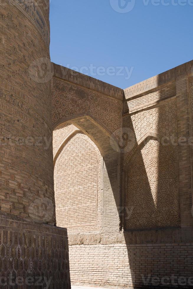 Old building with arch and passage. The ancient buildings of medieval Asia. Bukhara, Uzbekistan photo