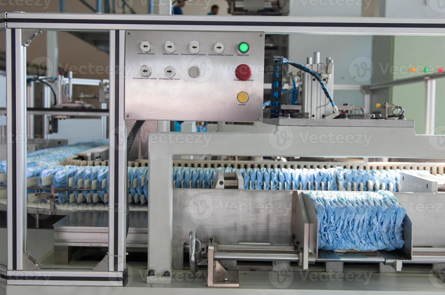 factory and equipment for the production of pampers. diapers on a conveyor belt photo