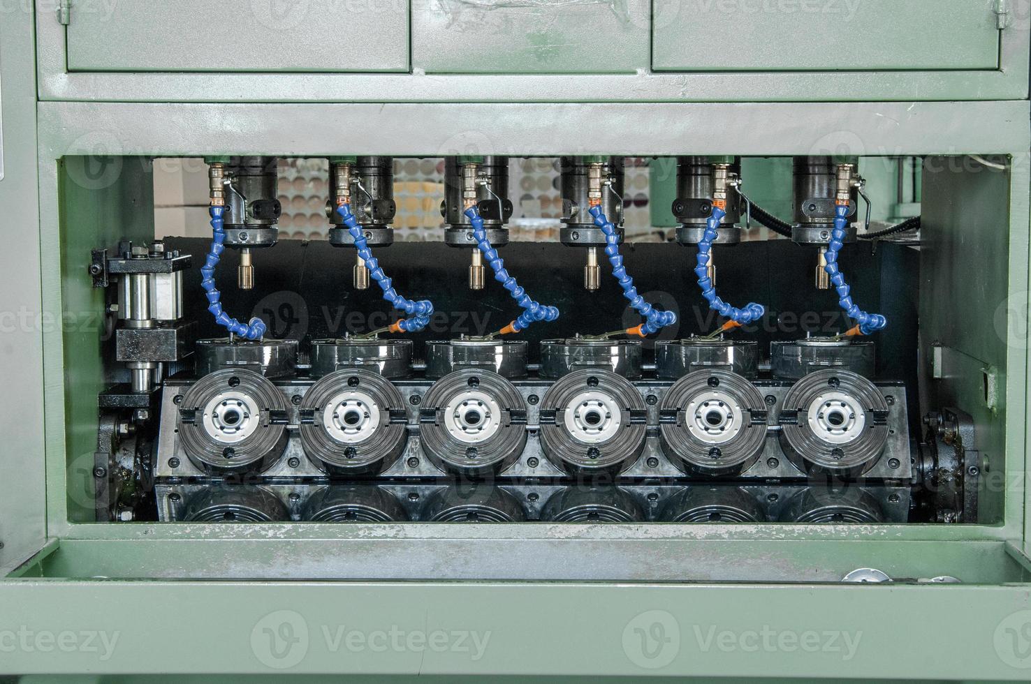 machines and equipment for threading on metal lids for car filters photo