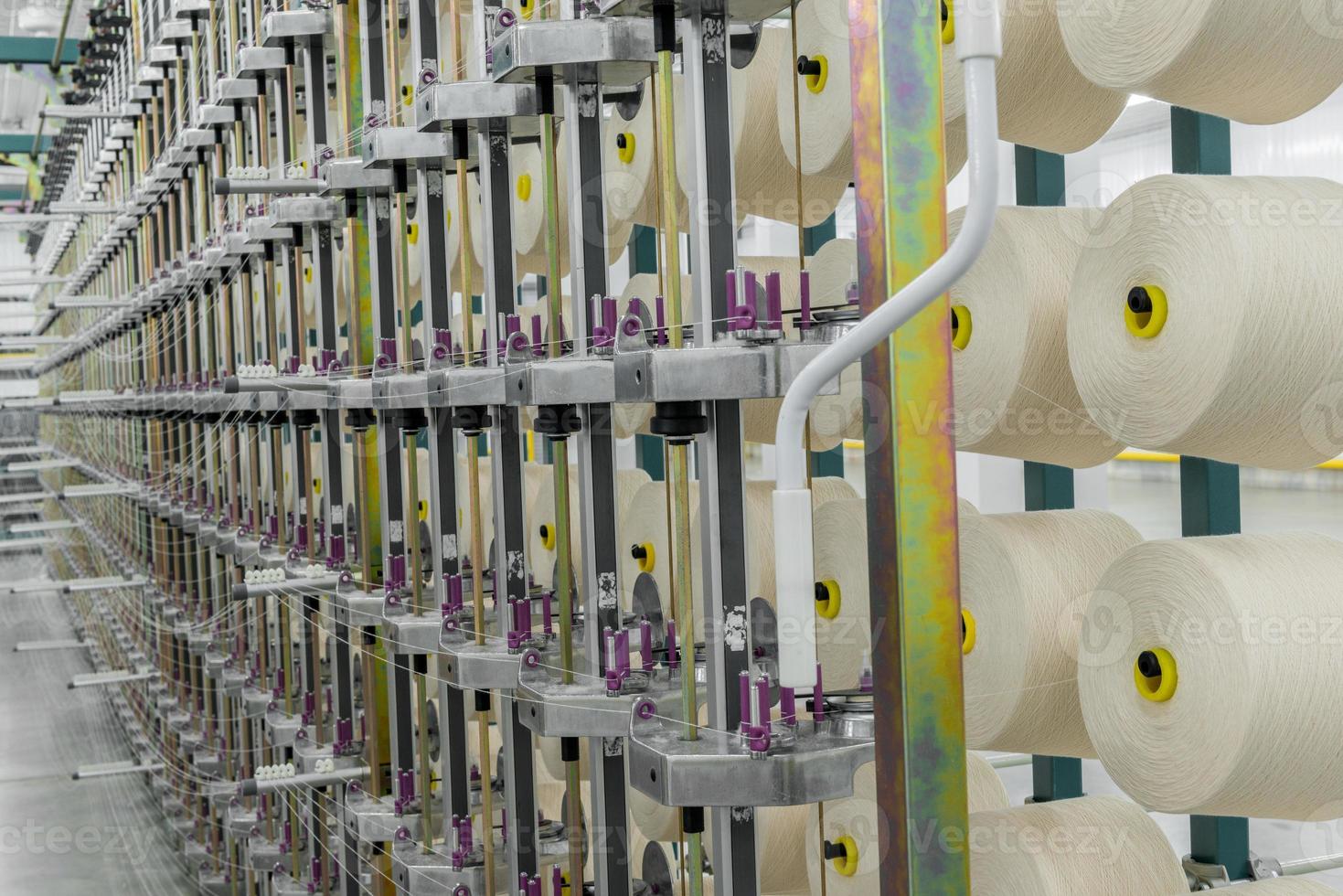 textile yarn on the warping machine. machinery and equipment in a textile factory photo