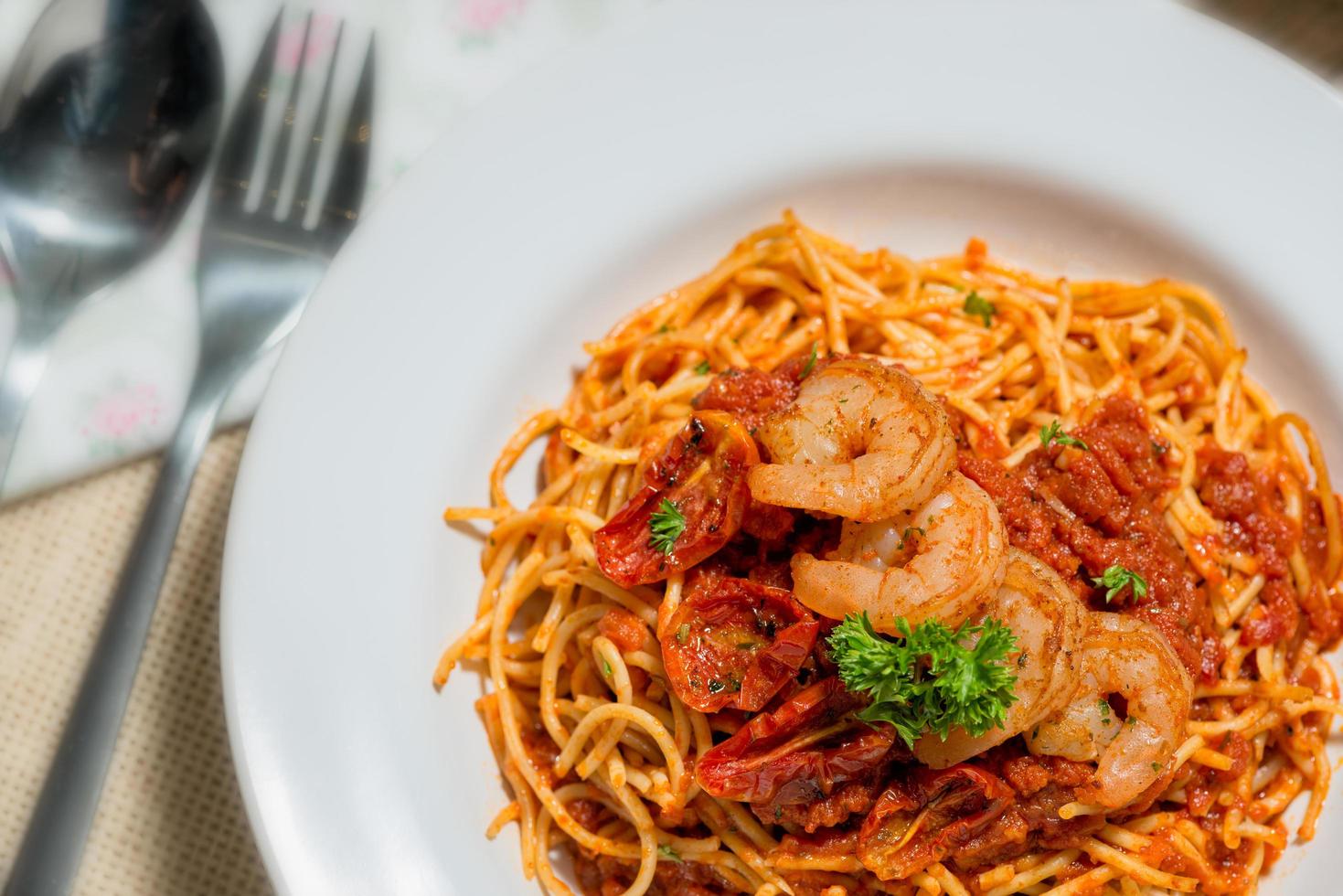 Spaghetti topped with shrimp sauce photo