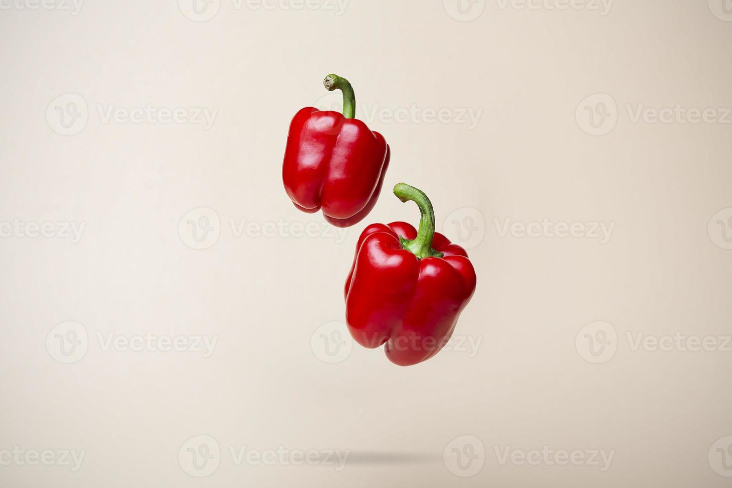 Fly Pepper, Red Paprika Bell Pepper on Beige Background photo