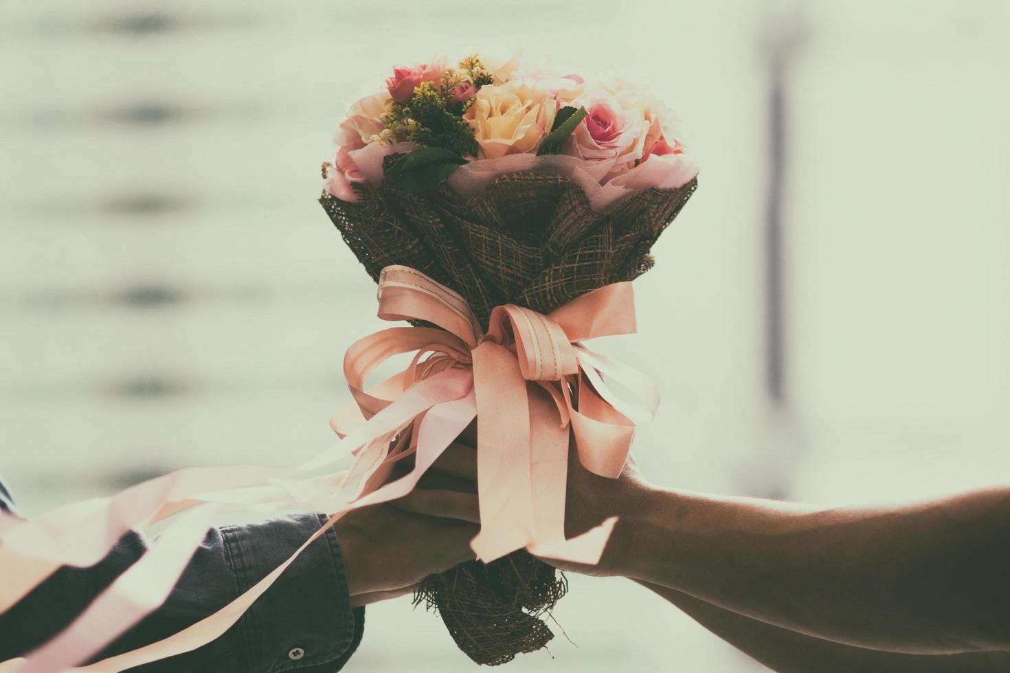 retro wedding bouquet with the flower in hands of the bride photo