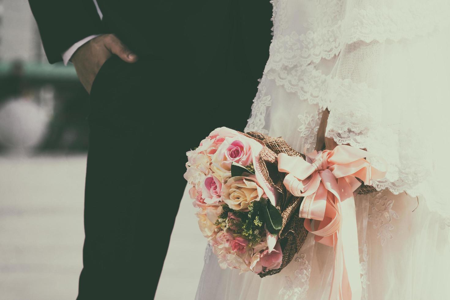 retro wedding bouquet with the flower in hands of the bride photo