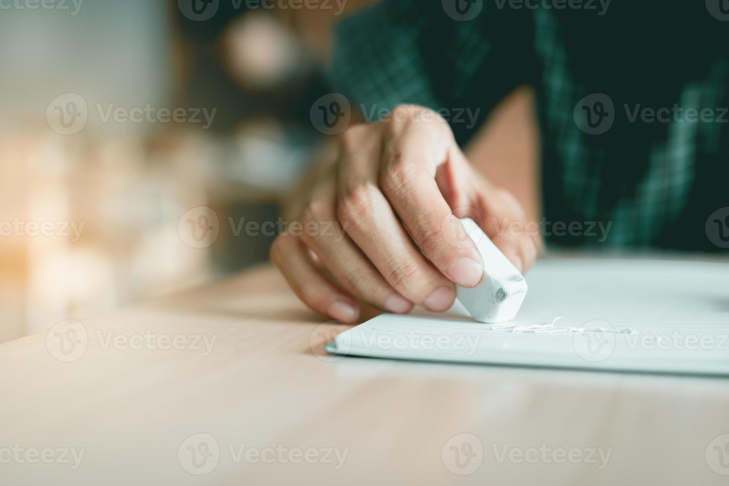 Close up student using eraser for edit mistake. photo