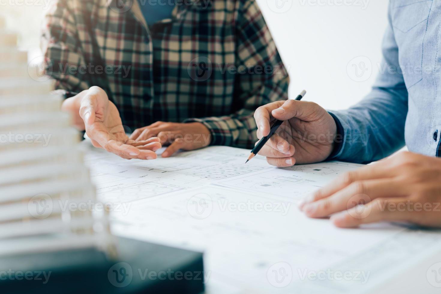 Investor man showing blueprint detail for people buying house. photo
