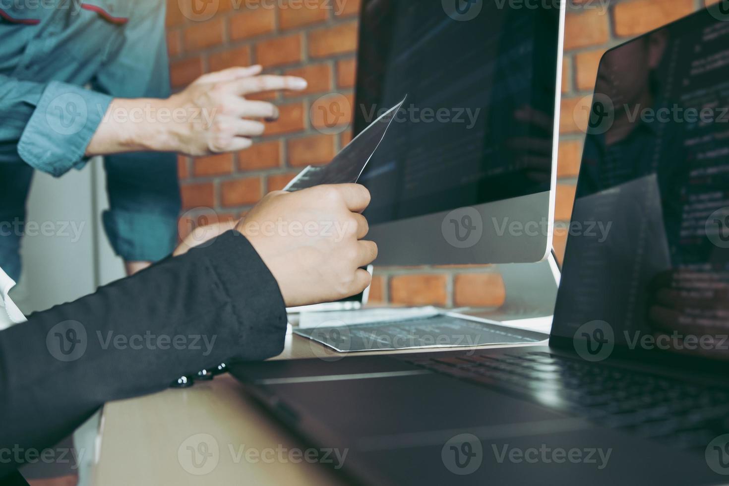 Professional development programmer cooperating meeting programming website working a software in office room. photo