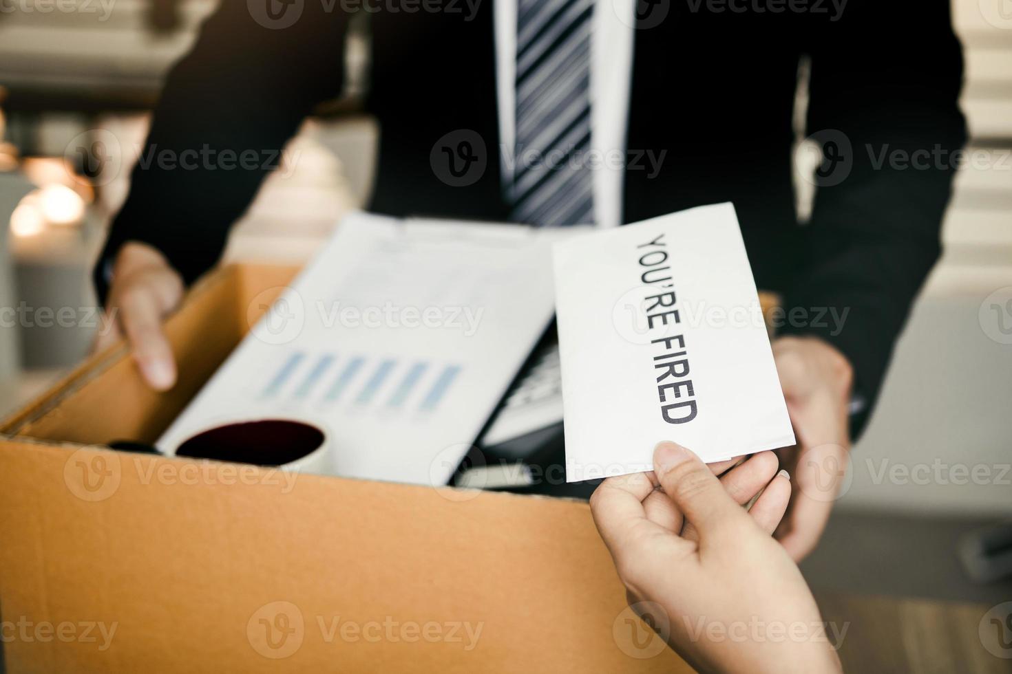 Female manager submits a resignation letter or envelope to the male employee at the office. photo