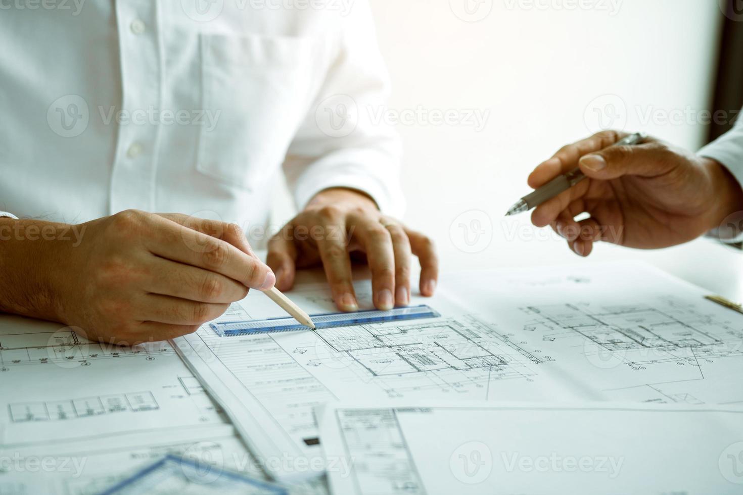 Team architect or engineering people discussion working on table together at a construction site. photo