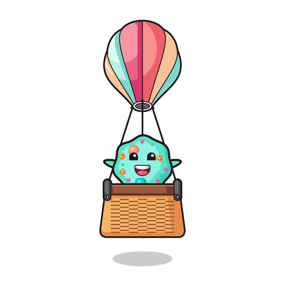 mascota de ameba montando un globo aerostático vector