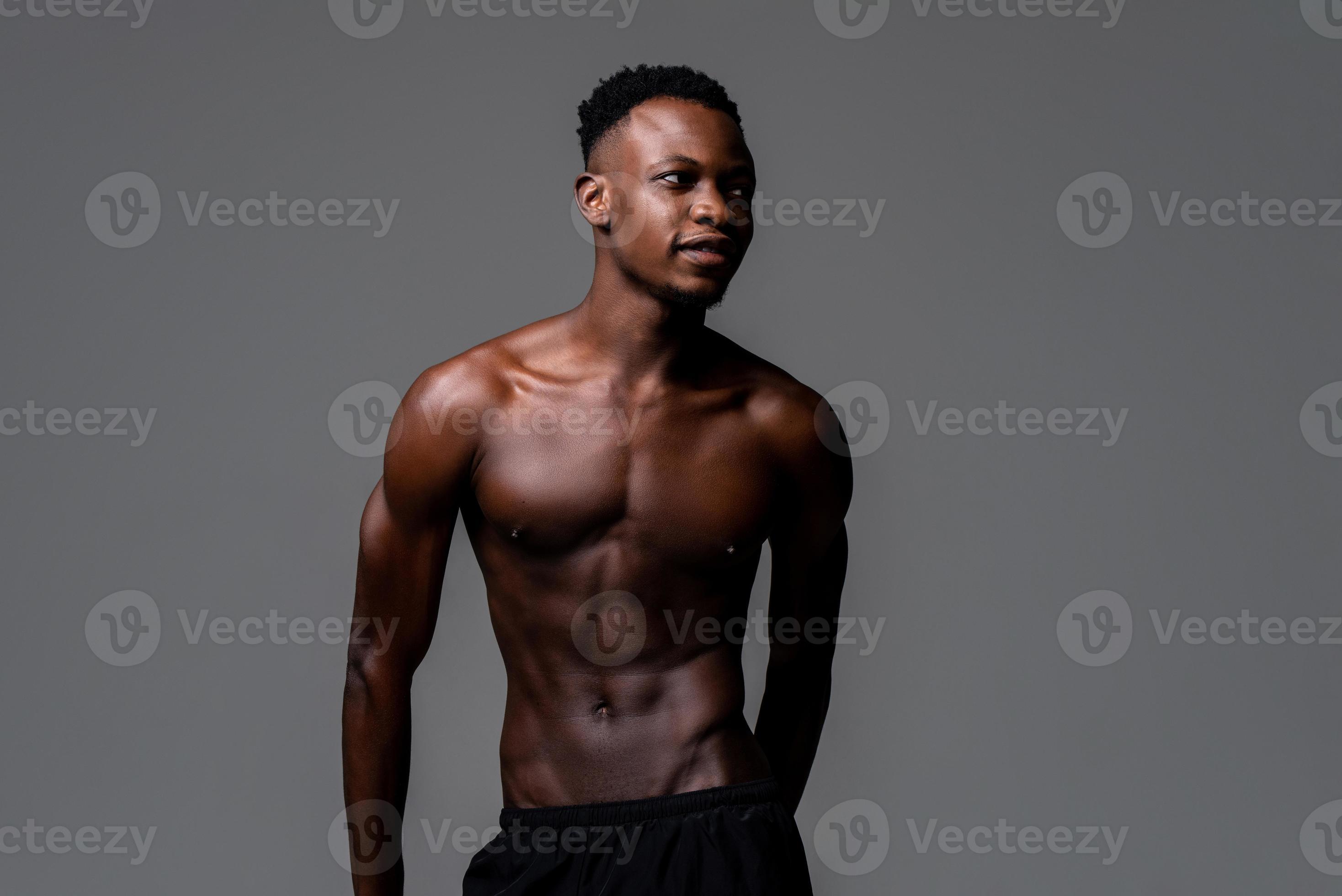 Shirtless young lean fit African man in isolated light gray background  5405738 Stock Photo at Vecteezy