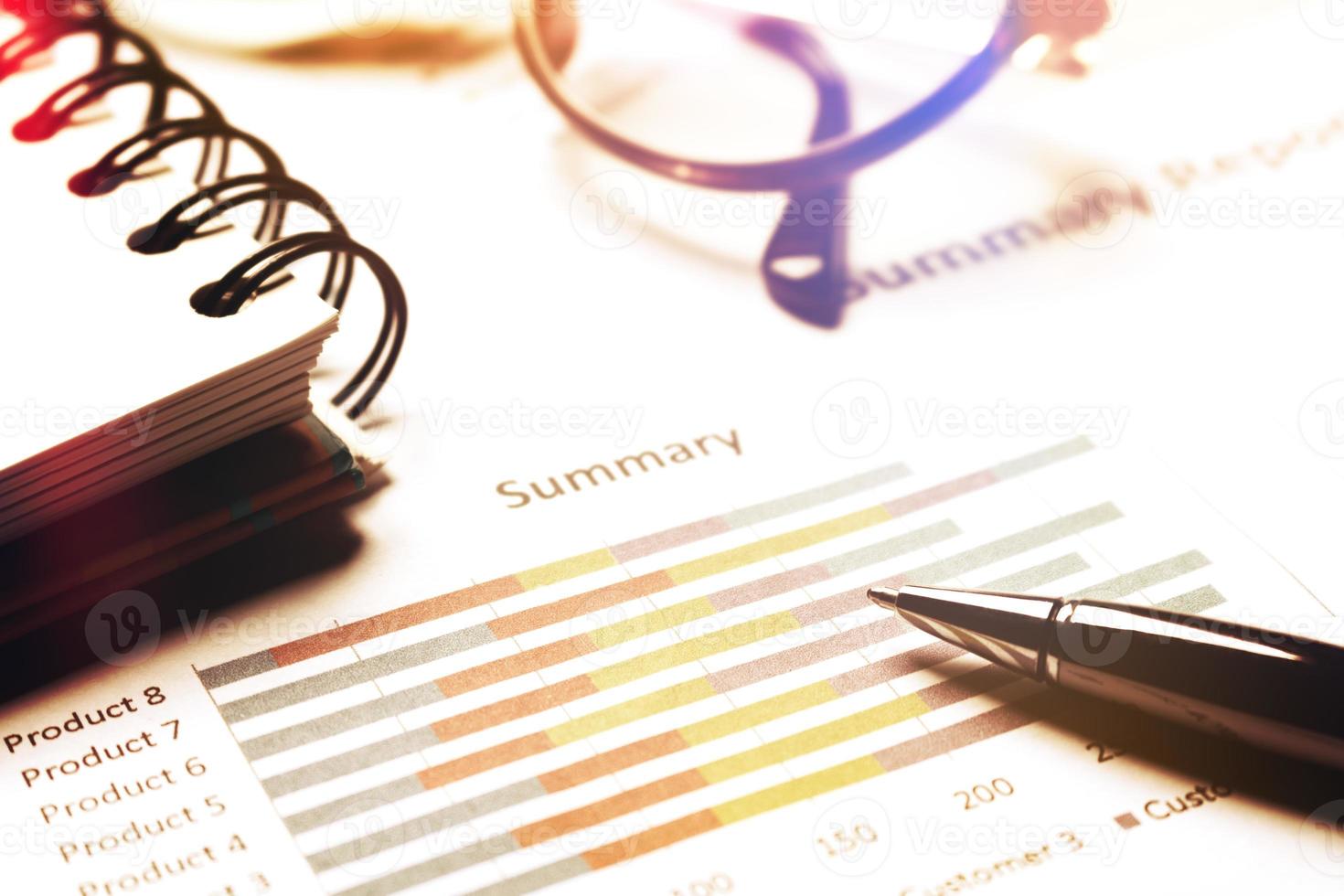 Summary report and financial analyzing concept, Pen and notebook and eyeglasses on paper report. photo