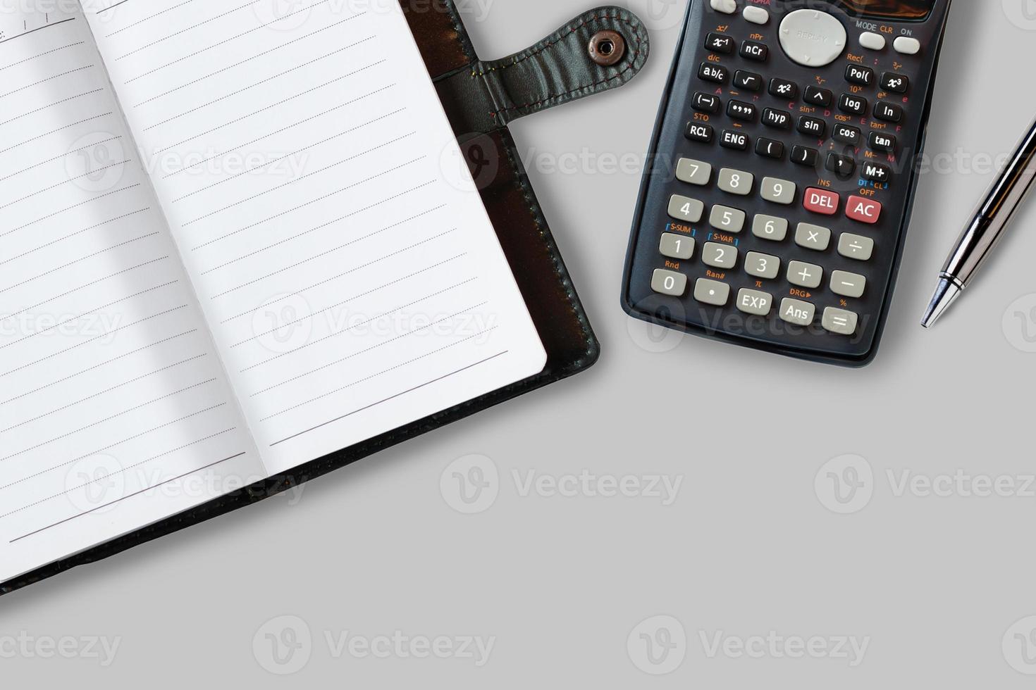 Office desk table with supplies, notebook, calculator and pen. Top view with copy space photo