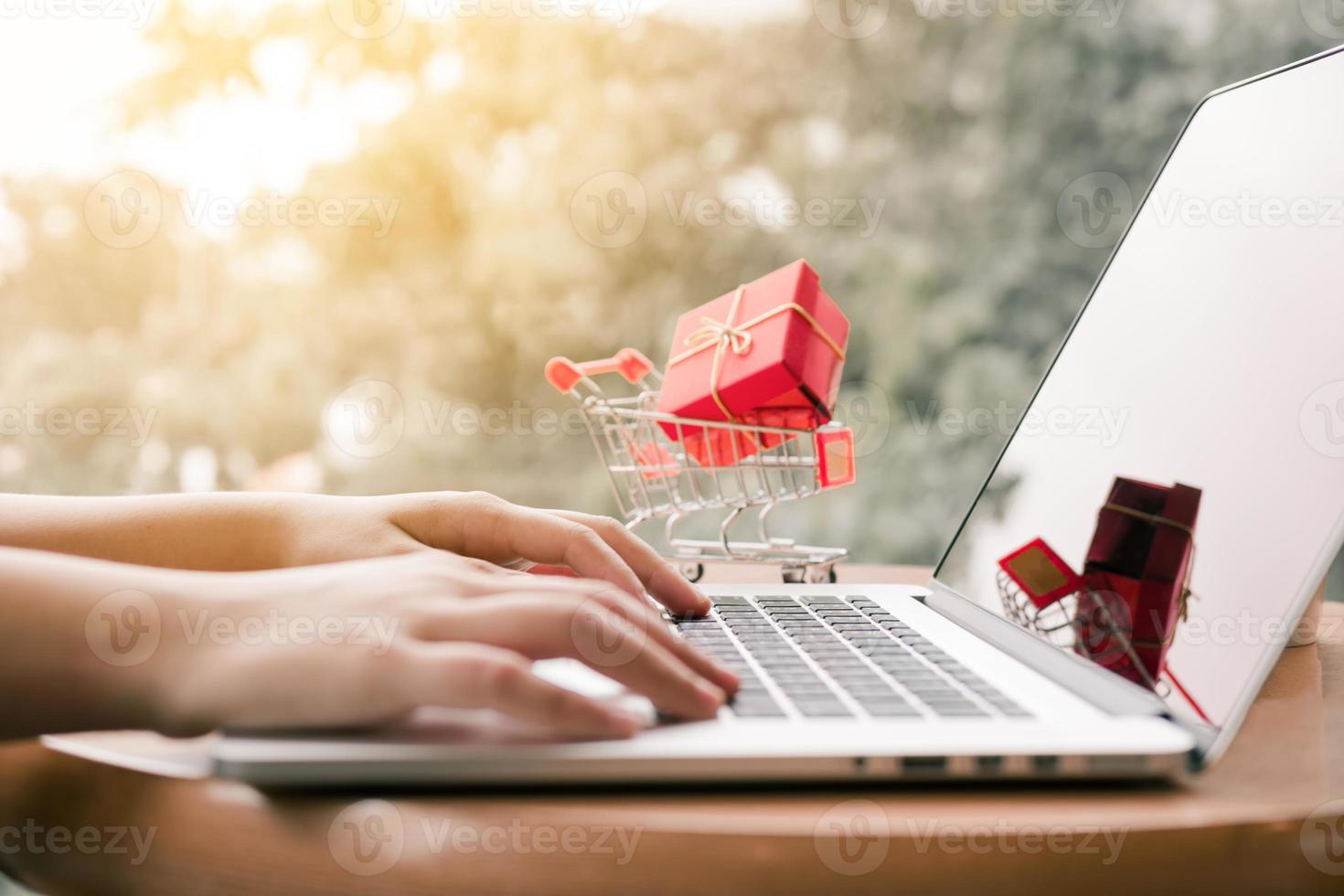 Online shopping concept with woman hand typing computer keyboard. photo