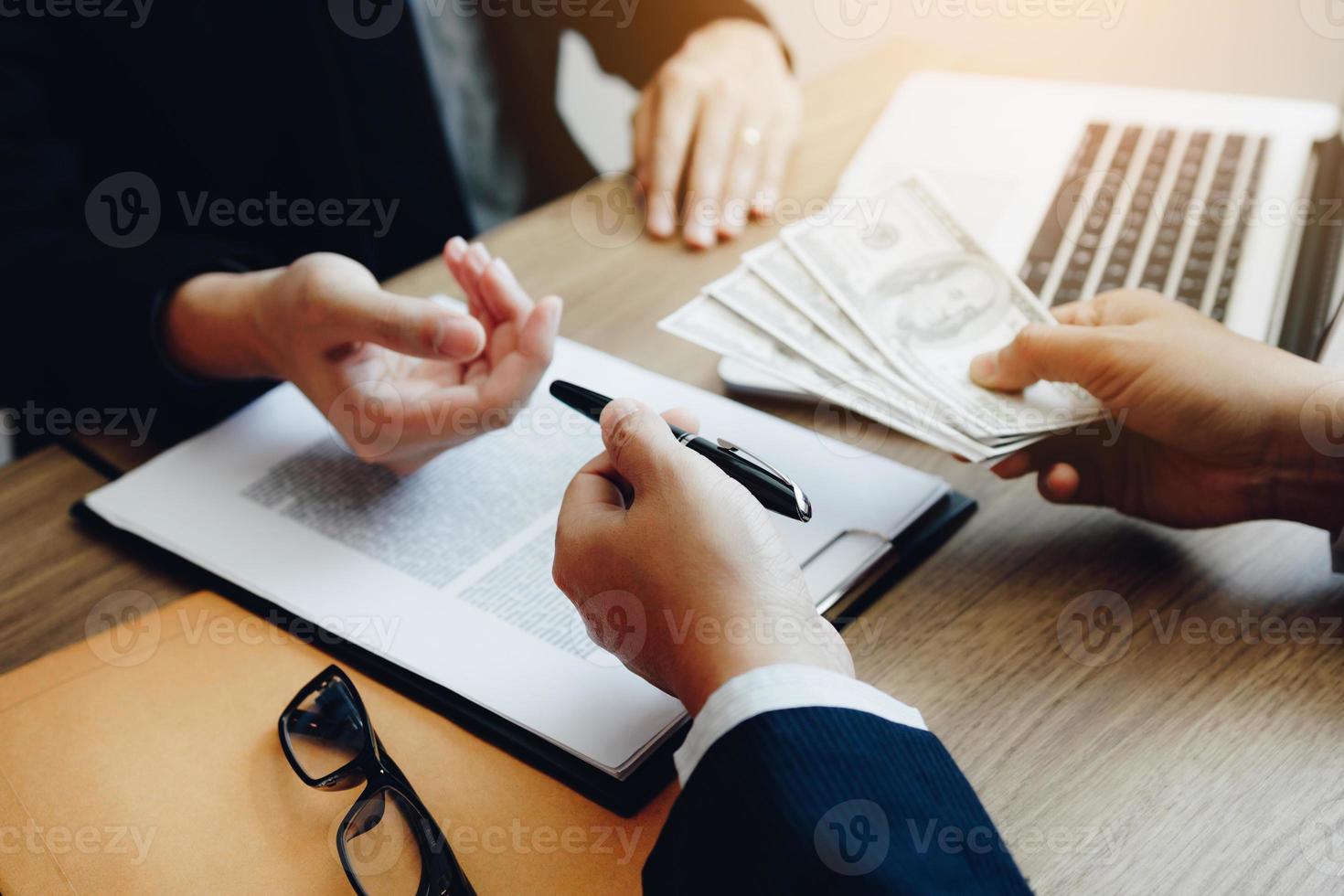 Partner has made a fraud in the contract of sale and being handed a cash and pen to the businessman signing the contract corruption bribery concept. photo