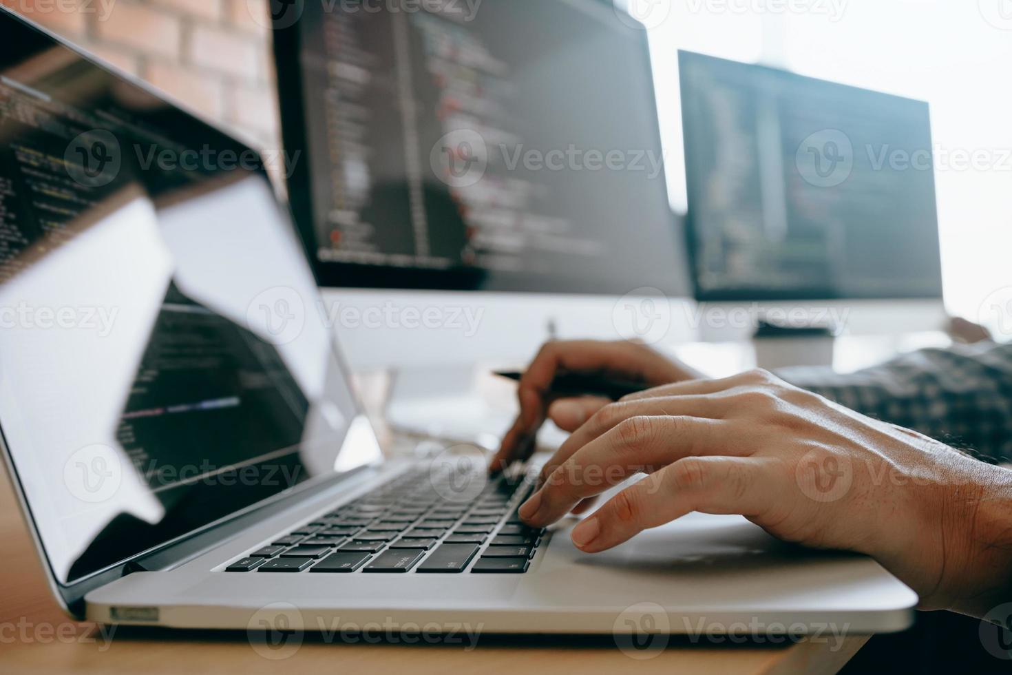 Close up of hands contemporary website developer man typing and writing code for program website and working with partner in office. photo