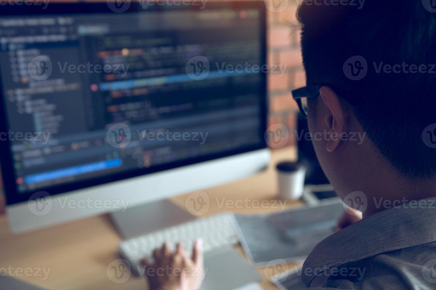 Asian man working code program developer computer web development working design software on desk in office. photo