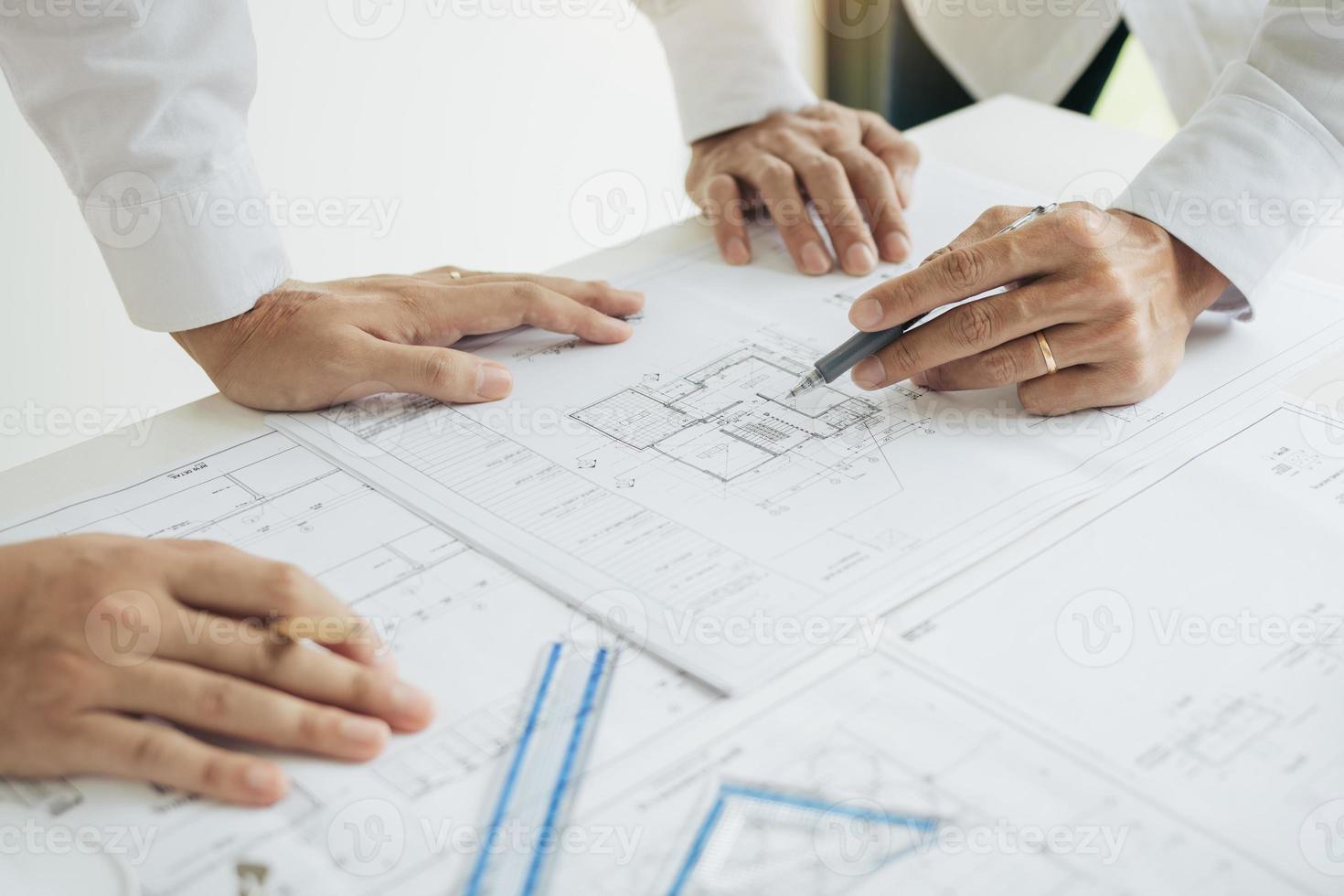 Team architect or engineering people discussion working on table together at a construction site. photo