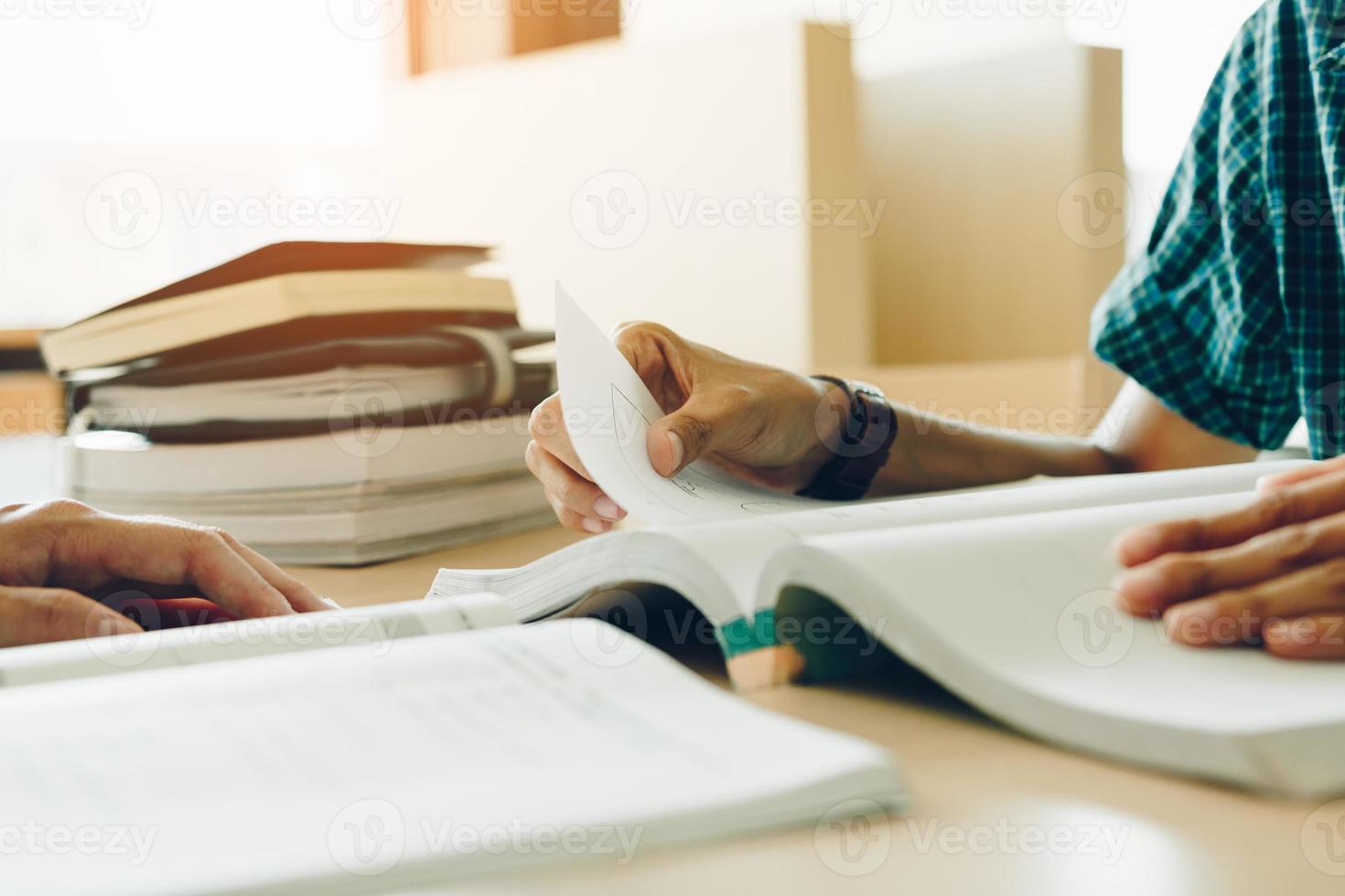 Teenager reading book in library at school. photo