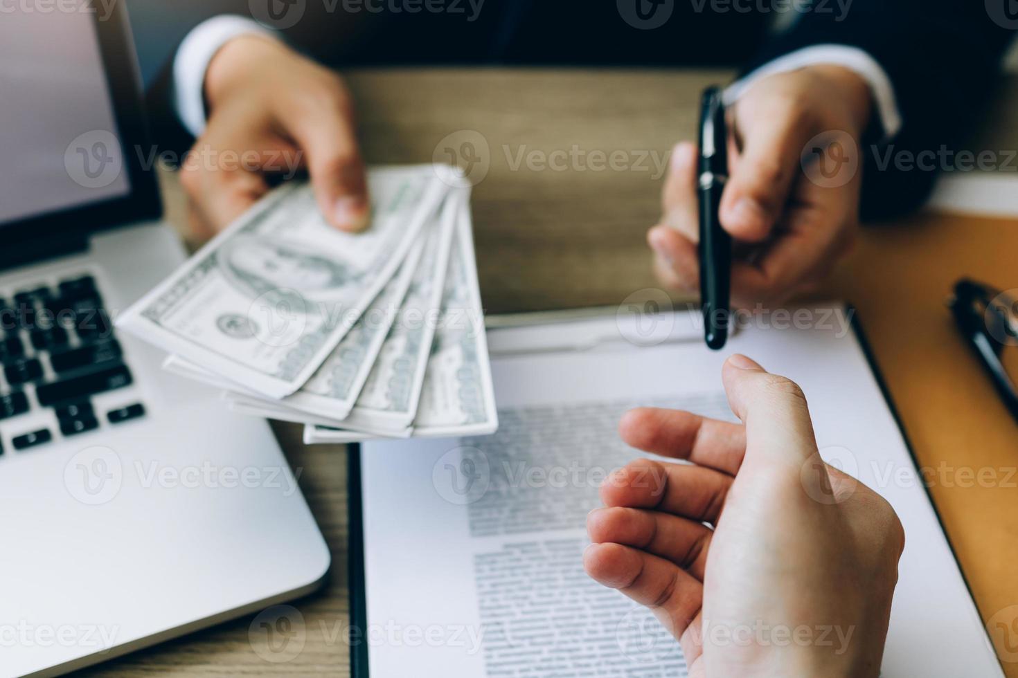 Partner has made a fraud in the contract of sale and being handed a cash and pen to the businessman signing the contract corruption bribery concept. photo