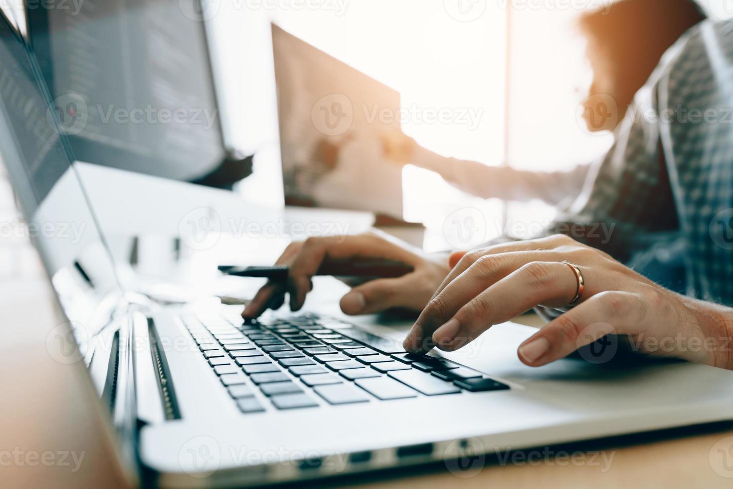 Close up of hands contemporary website developer man typing and writing code for program website and working with partner in office. photo