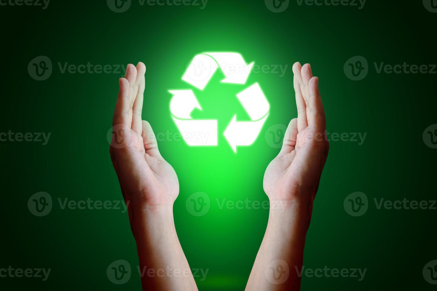 Asian young hand holding recycle  icon and green background. photo