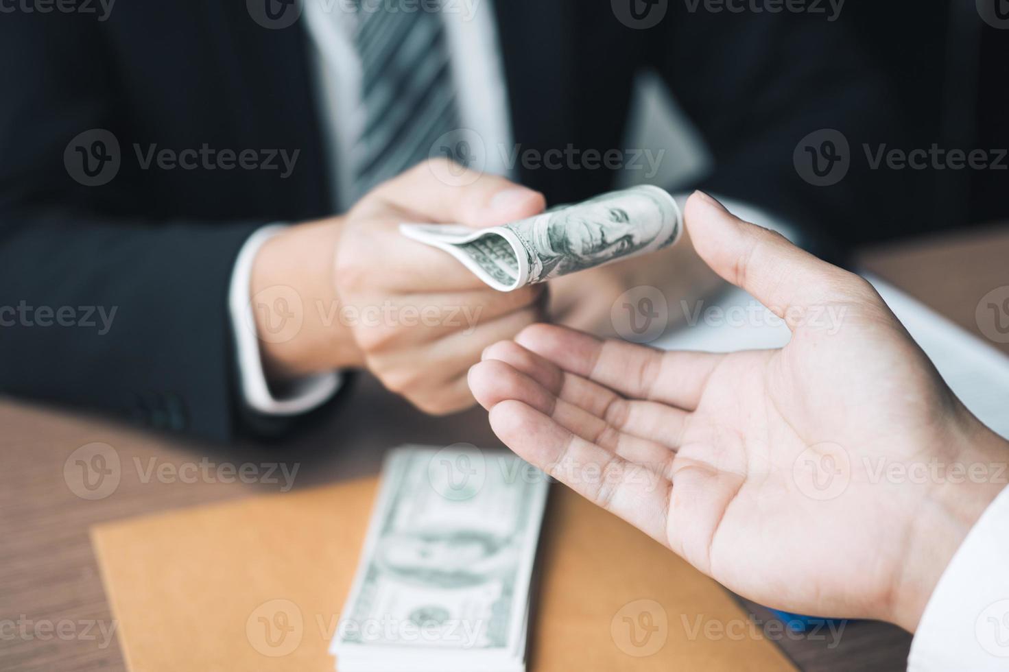 los empresarios están recibiendo dinero que es un soborno de sus socios con los cuales ambos son corruptos en la sala de la empresa. foto