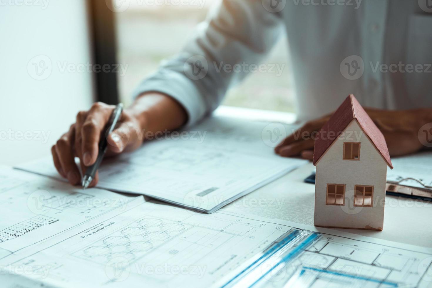 The partnership engineering man or co-workers working on a project and discussing together with looking at blueprint paperwork. photo