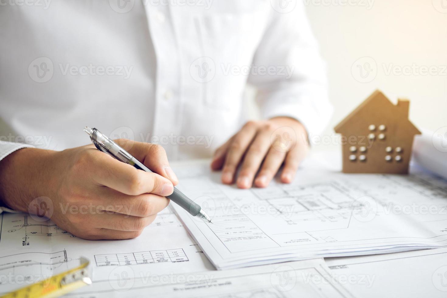 Architects working with blueprints and discussing project together at the meeting in the office. photo