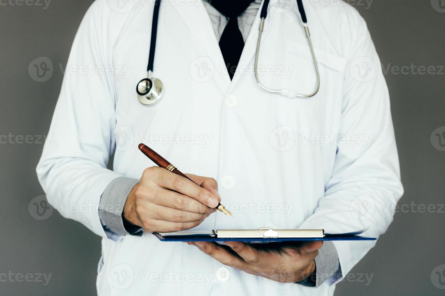 The doctor is taking notes in the hospital. photo