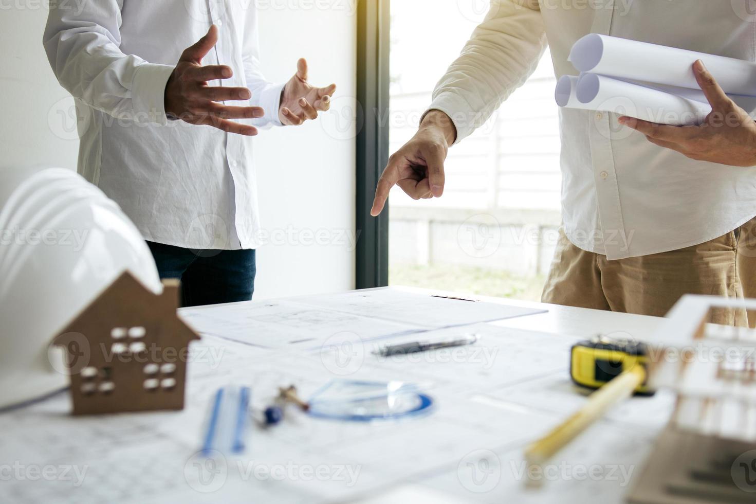 Team architect or engineering people standing working discussion together at a construction site. photo