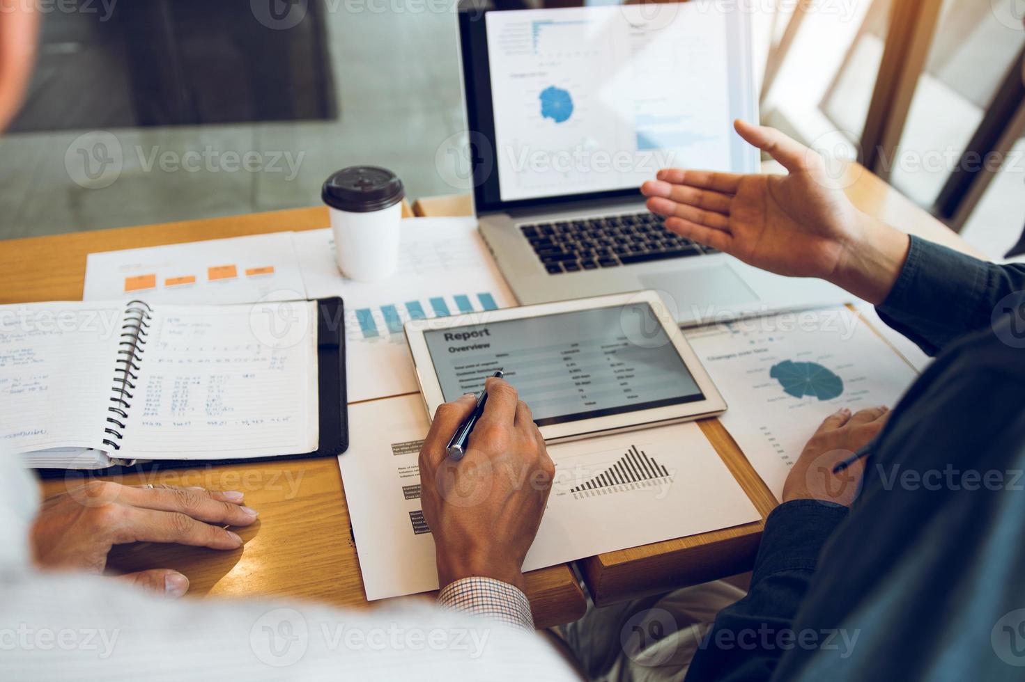 Business partnership coworkers analysis cost work progress and using a tablet to graph company financial budget report and planning for future in office room. photo
