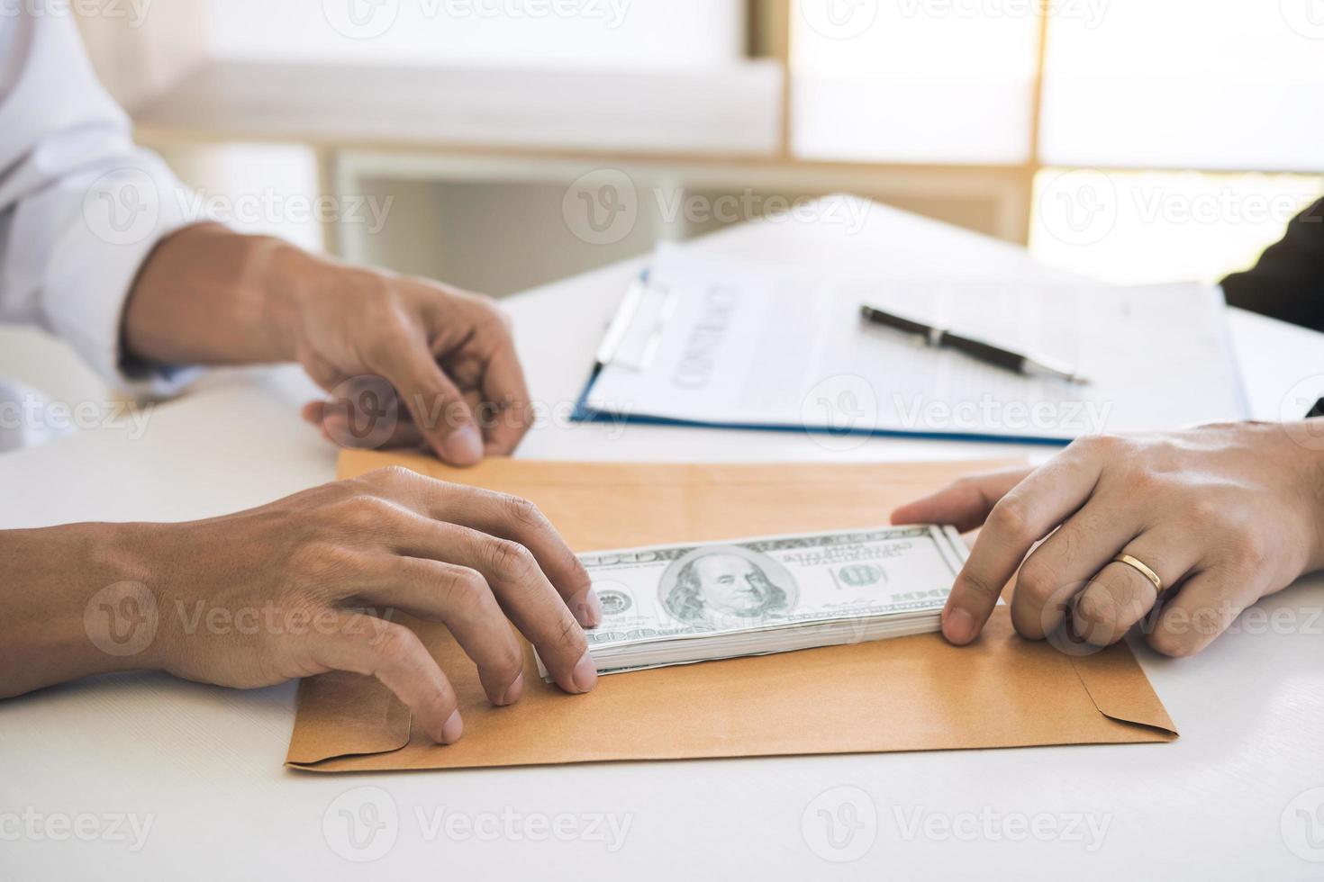 Partner has made a fraud in the contract of sale and being handed a cash and pen to the businessman signing the contract corruption bribery concept. photo