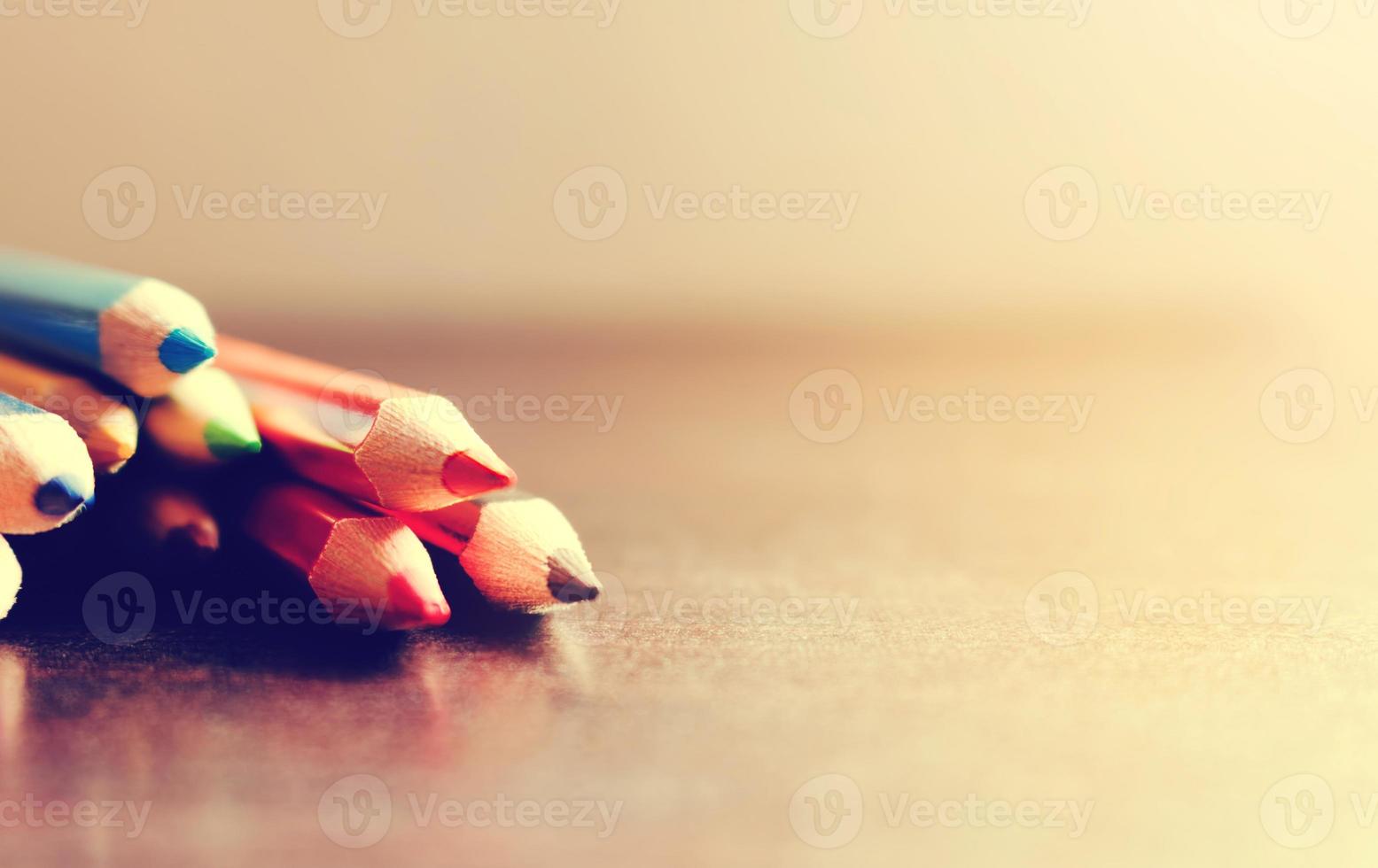 Soft focus of color pencil stack on desk. photo