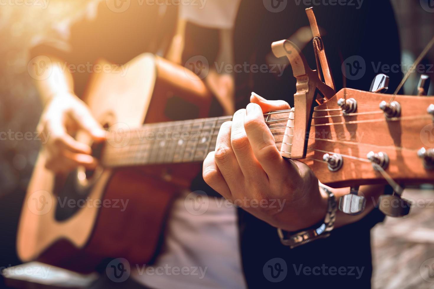 el hombre hipster asiático coge el acorde de la mano izquierda y toca música. foto