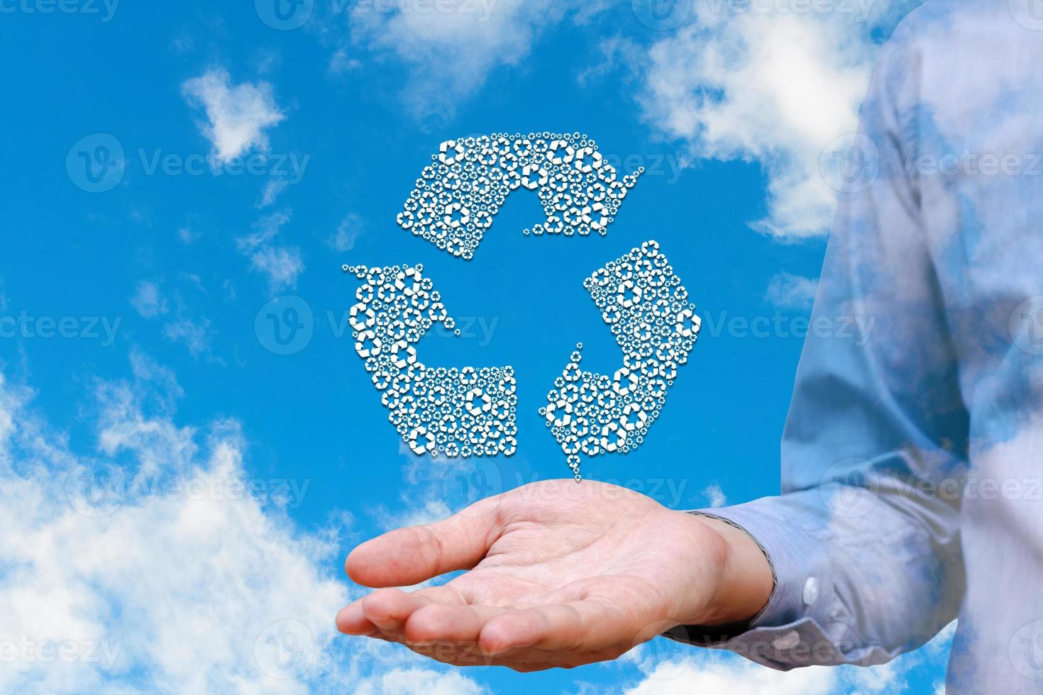 Man holding recycled icons on nature sky background, Environment concept. photo
