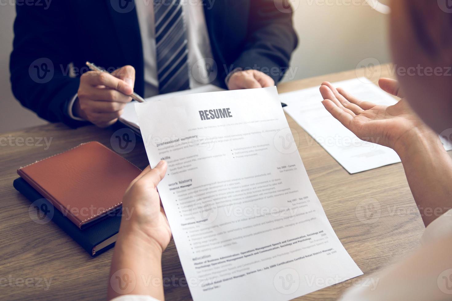 Smart businessman professional man in suit executive gesturing and talking in meeting with interview employee women about work in modern office. photo