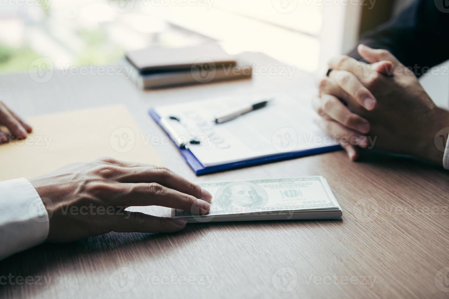 Partner has made a fraud in the contract of sale and being handed a cash and pen to the businessman signing the contract corruption bribery concept. photo