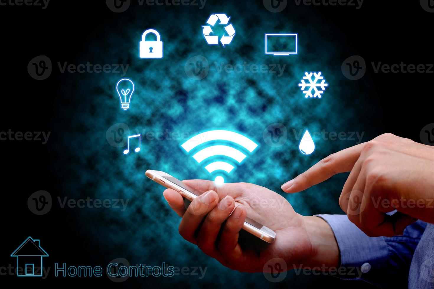 Man using smart phone or remote home control online home automation system. photo